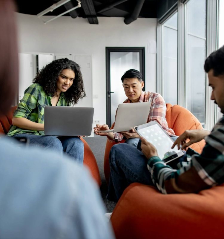 teammates-working-on-laptops-and-tablets-in-coworking-space.jpg